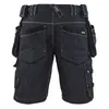 The back view of a pair of dark blue work shorts with multiple pockets. Produktbild-Vorschau