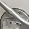 A close-up shot of a metal ironing board frame with a slight dent. Podgląd zdjęcia produktu