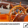 A close-up of a wooden ship's wheel with a chest in the foreground. Produktbild-Vorschau