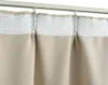 Close-up of beige curtains hanging from a track. Produktbild-Vorschau