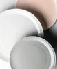 Several plates are arranged diagonally on a white and gray background. Produktbild-Vorschau