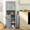 A gray storage cabinet with glass doors and open shelves, filled with various kitchen items, stands in a kitchen setting. Náhľad obrázku produktu