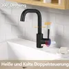 A black faucet is shown in a bathroom sink with white tiled walls and a wooden shelf above. Podgląd zdjęcia produktu