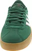 A close-up, front-facing view of a green Adidas sneaker with white stripes and a brown sole. Produktbild-Vorschau
