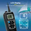 A marine radio with an LCD display and buttons, shown in the foreground with a sailboat and a person in the background. Anteprima dell’immagine prodotto
