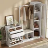 A white wardrobe set with a mirror, clothes rack, and shoe storage, displayed in a room setting. Produktbild-Vorschau