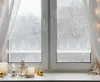 A decorated window sill with Christmas decorations and a snowy winter scene visible through the window. Produktbild-Vorschau