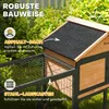A close-up view of a wooden and metal pet house with a wire mesh run, set against a blurred green outdoor background. Produktbild-Vorschau