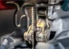 A close-up view of a jigsaw blade attached to a tool. Voir les images du produit