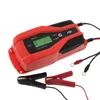 A red and black battery charger with a digital display and attached cables with clamps and ring terminals, shown on a white background. Náhľad obrázku produktu