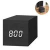 A black digital alarm clock with white LED display. Produktbild-Vorschau
