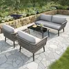 A patio furniture set is arranged on a stone patio in a garden setting. Podgląd zdjęcia produktu