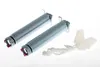 Two metal springs and some white plastic parts with a rope, arranged on a white background. Produktbild-Vorschau