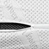 A close-up view of a white mattress cover with a zipper partially open, revealing a dark, textured material underneath. Podgląd zdjęcia produktu