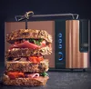 A stacked sandwich in front of a copper toaster. Náhľad obrázku produktu