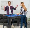 A man and a woman are playing pool on a table in a living room. Produktbild-Vorschau