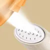 A close-up shot of a garment steamer spraying steam onto a piece of orange fabric. Produktbild-Vorschau