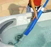 A person is using a blue and white cleaning tool in a hot tub. Produktbild-Vorschau