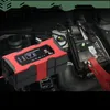 A car battery charger connected to a car battery in an engine bay. Produktbild-Vorschau