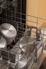 Pots and pans are arranged in a dishwasher rack. Podgląd zdjęcia produktu