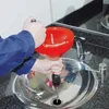 A person is using a red drain cleaning tool in a sink. Produktbild-Vorschau