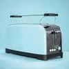 A light blue toaster sits on a light blue surface against a light blue background. Voir les images du produit