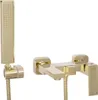 A gold-colored bathtub faucet with a handheld showerhead, isolated on a white background. Produktbild-Vorschau