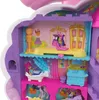 A detailed interior view of a Polly Pocket unicorn beauty salon playset, showcasing multiple levels with miniature furniture and accessories. Produktbild-Vorschau