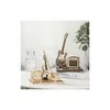 A wooden model of an electric guitar and amplifier, and a wooden model of a violin and its case, are displayed on a white surface. Voir les images du produit