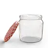 A clear glass jar with a red and white checkered lid, shown with the lid slightly ajar. Voir les images du produit