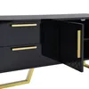 A close-up, angled view of a black, high-gloss TV cabinet with gold accents and legs. One of the cabinet doors is open, revealing a textured interior. Produktbild-Vorschau