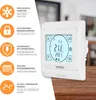 A white digital thermostat is shown on a wooden surface, with a graphic overlay on the left detailing its features. Náhled obrázku produktu