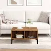 A living room scene with a white sofa, a wooden coffee table, and a rug. Produktbild-Vorschau