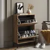 A shoe cabinet with shoes inside, placed in a room setting with a painting and a vase on top. Náhľad obrázku produktu