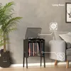A living room scene featuring a record player stand with vinyl records, a guitar, and a sofa. Produktbild-Vorschau