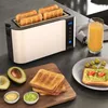 A toaster with four slices of bread, along with avocado toast, olives, and orange juice, arranged on a kitchen counter. Anteprima dell’immagine prodotto