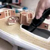 A person is using a vacuum cleaner to clean a model boat and its components. Náhled obrázku produktu