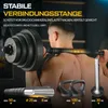 A man is shown using a barbell with a special connecting rod that rests on his shoulders. Produktbild-Vorschau