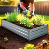A person is gardening in a raised metal garden bed filled with plants. Produktbild-Vorschau
