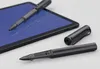 A black LAMY AL-star EMR stylus and its cap are placed on a surface next to a tablet with a blue screen. Podgląd zdjęcia produktu
