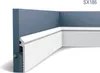 A white skirting board with a channel for cables, installed at the corner of a blue wall. Náhled obrázku produktu