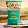 A bag of sheep and goat cereal with a farm field in the background. Voir les images du produit