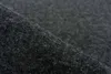 A close-up, angled view of dark grey carpet tiles. Produktbild-Vorschau