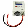 A white electronic battery tester with a blue display screen and various buttons, connected to red and black alligator clip wires. Náhled obrázku produktu