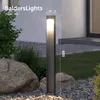 A modern outdoor light post in a garden setting with rocks and plants. Anteprima dell’immagine prodotto