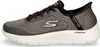 A side view of a gray Skechers slip-on walking shoe with a white sole. Anteprima dell’immagine prodotto