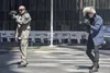 Two men in tactical gear aiming weapons in an urban environment. Podgląd zdjęcia produktu