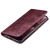 A burgundy flip cover case for a smartphone is shown from a diagonal angle, with the cover partially open to reveal the phone screen. Produktbild-Vorschau