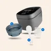 A rice cooker and its accessories are displayed against a light beige background. Produktbild-Vorschau
