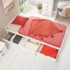 A white bed with storage drawers, featuring red and orange bedding and a throw blanket. Produktbild-Vorschau
